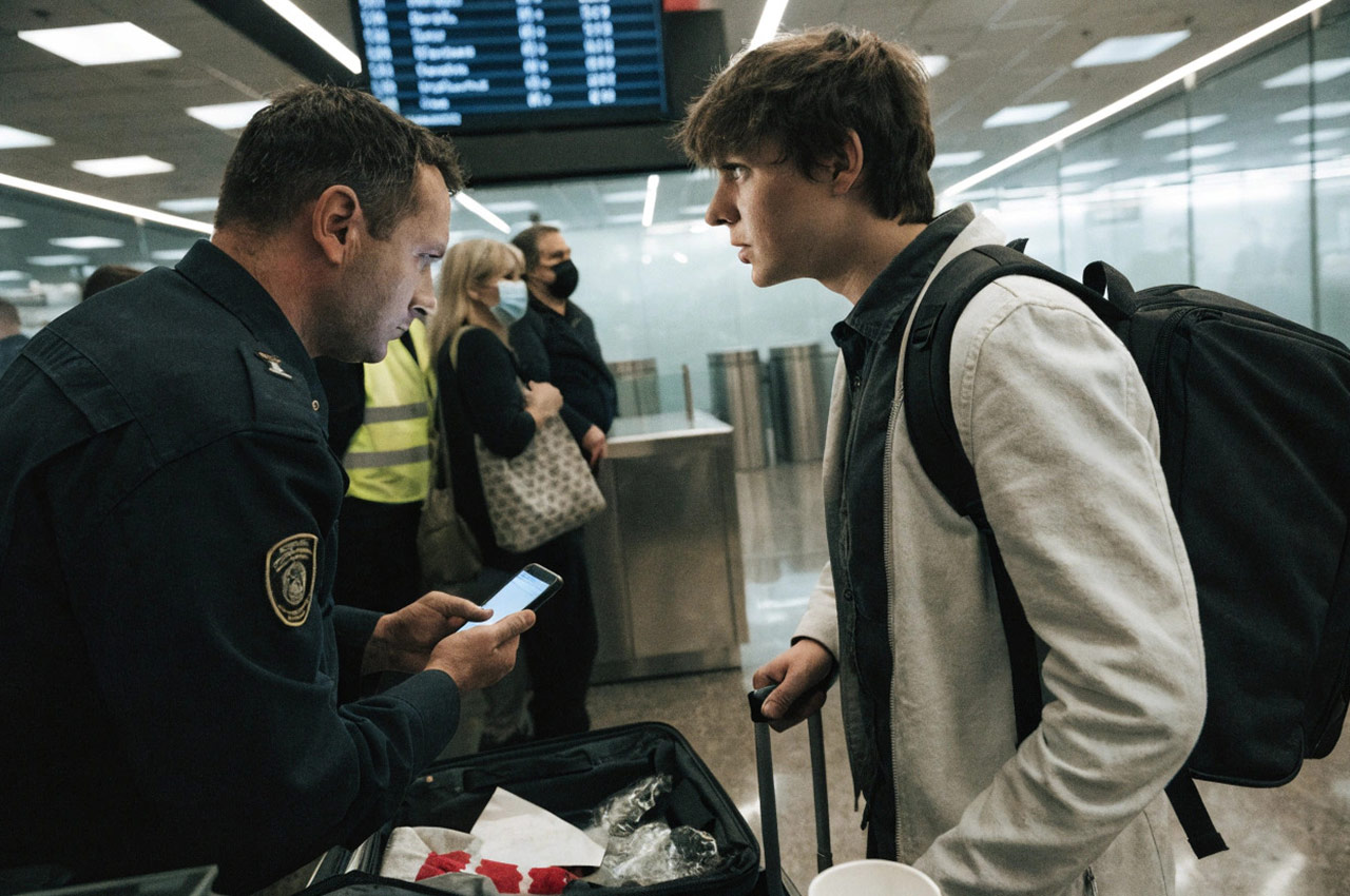 Border guard checking a traveler's phone at the Russian border