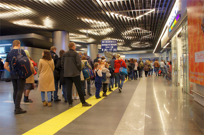 Passengers at the board with delayed flights at the airport